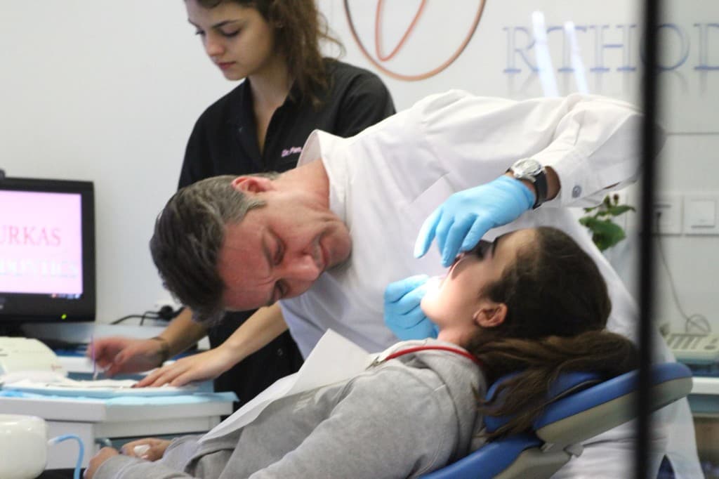 Dr Fourkas performing orthodontic procedure